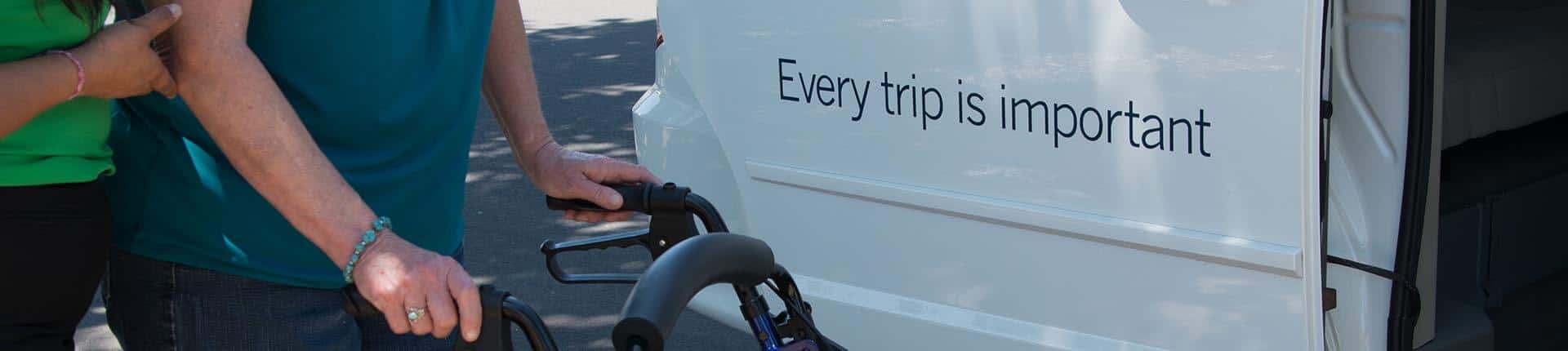 Person in wheelchair next to para transit bus reading "Eavry trip is important"